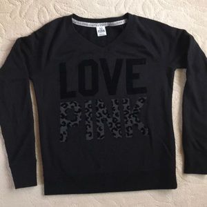 Pink v-neck sweatshirt.